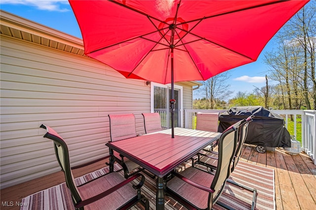 wooden terrace with outdoor dining area