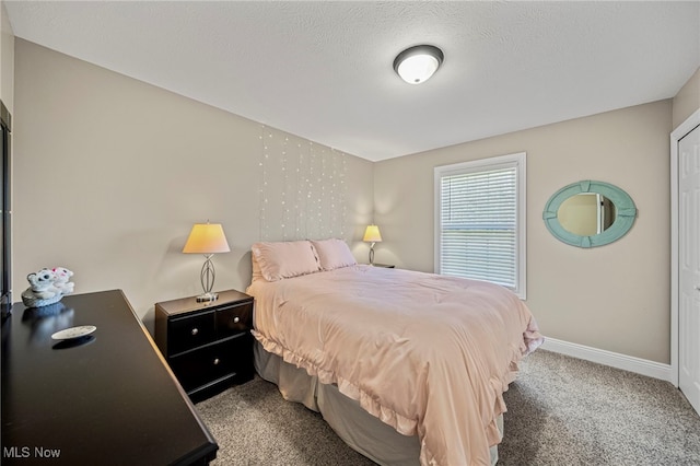 carpeted bedroom featuring baseboards