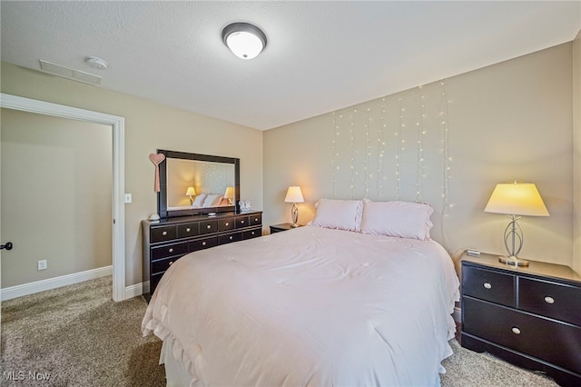 bedroom featuring baseboards, carpet, and visible vents