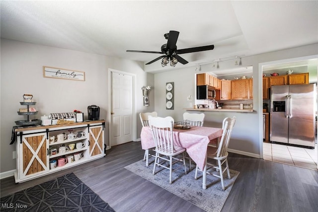 7377 Sierra Madre Trl, Boardman, OH 44512 - dining space featuring baseboards, rail lighting, ceiling fan, and wood finished floors