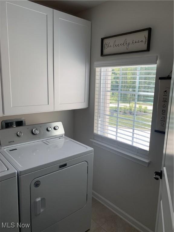 840 Sunrise Cir, Aurora, OH 44202 - washroom with washer and dryer, baseboards, tile patterned flooring, and cabinet space