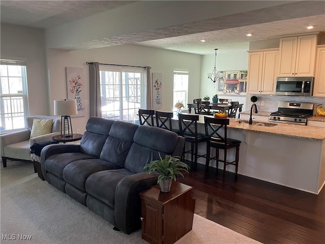 840 Sunrise Cir, Aurora, OH 44202 - living room with dark wood-style flooring, recessed lighting, a textured ceiling, and a wealth of natural light