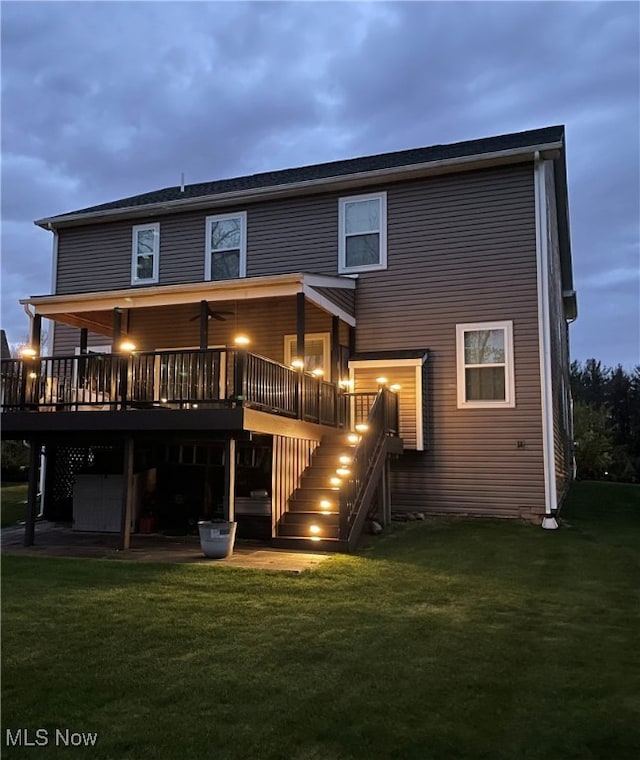 840 Sunrise Cir, Aurora, OH 44202 - rear view of house with stairs, a lawn, and a wooden deck