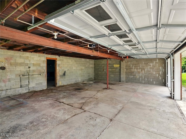 garage with concrete block wall