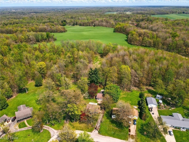 aerial view featuring view of golf course and a forest view