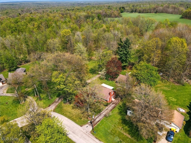 drone / aerial view featuring a wooded view