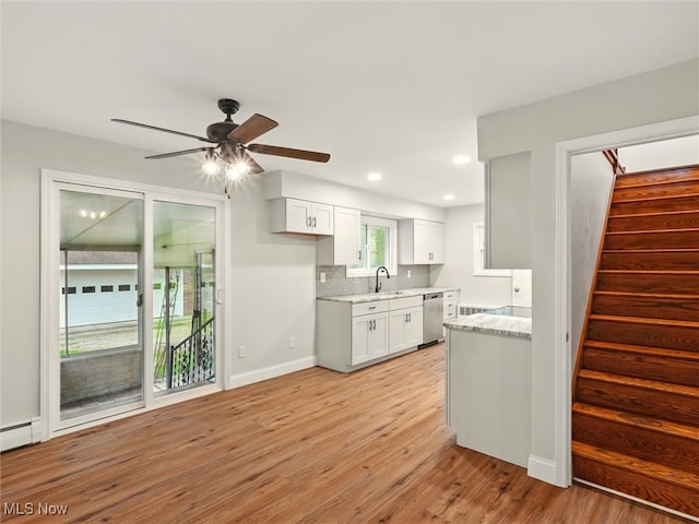 kitchen featuring decorative backsplash, a ceiling fan, light wood-type flooring, dishwasher, and white cabinetry