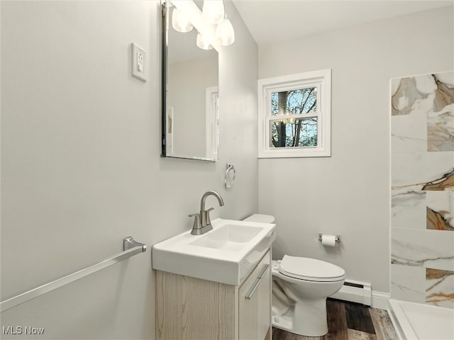 bathroom with vanity, toilet, a marble finish shower, wood finished floors, and a baseboard radiator