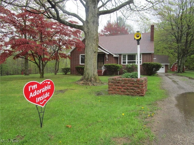 single story home with brick siding, roof with shingles, a front yard, and a chimney