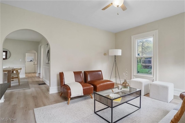 460 Carthage Ave, Kent, OH 44240 - living area featuring visible vents, light wood-style floors, baseboards, ceiling fan, and arched walkways