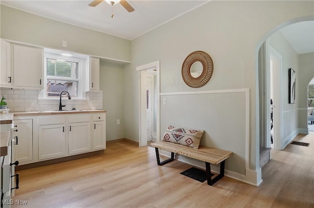 460 Carthage Ave, Kent, OH 44240 - kitchen featuring ceiling fan, a sink, arched walkways, backsplash, and visible vents