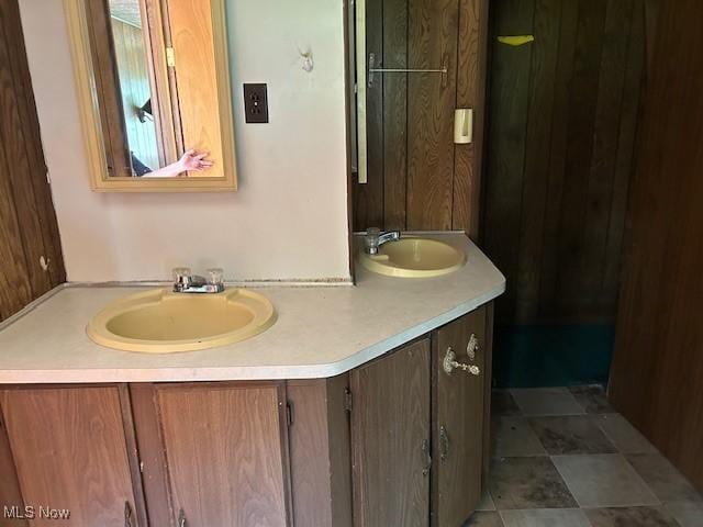 bathroom with a sink and double vanity