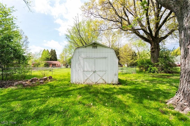 view of shed featuring fence