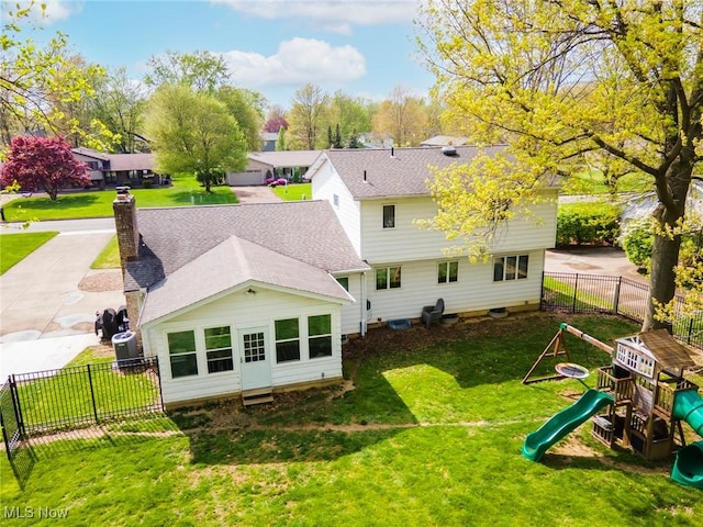 8459 Four Seasons Trl, Poland, OH 44514 - rear view of property featuring a chimney, a lawn, central AC unit, fence, and a playground