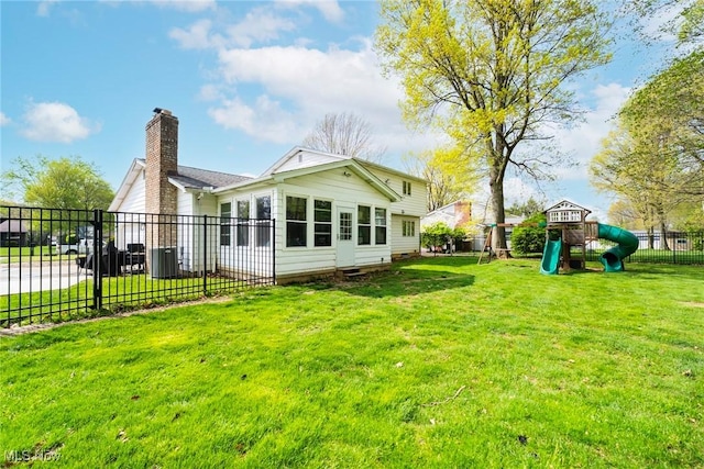 8459 Four Seasons Trl, Poland, OH 44514 - back of property with a lawn, a playground, fence, and a chimney