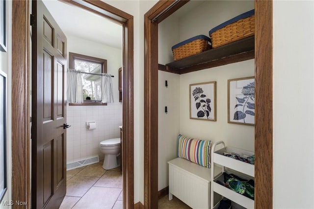 8459 Four Seasons Trl, Poland, OH 44514 - bathroom with tile patterned flooring, toilet, and tile walls