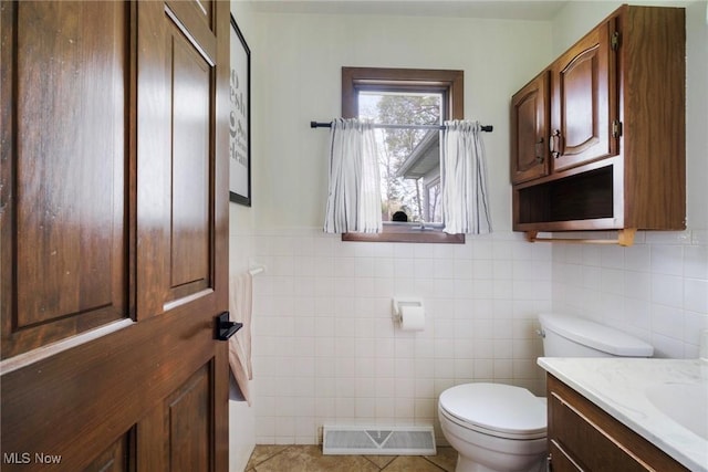 8459 Four Seasons Trl, Poland, OH 44514 - bathroom featuring visible vents, tile walls, tile patterned flooring, vanity, and toilet