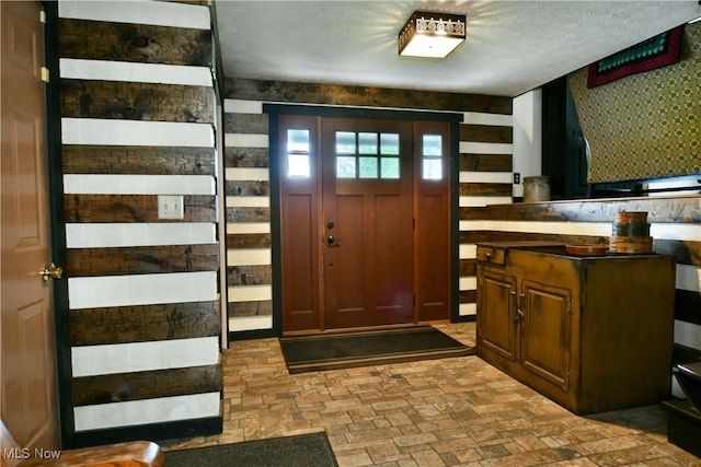 foyer featuring brick floor