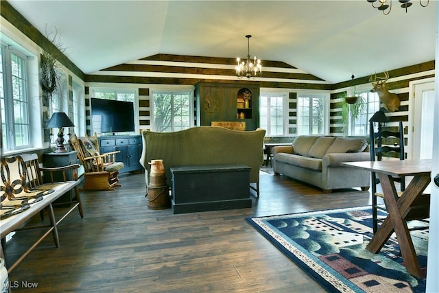 living area featuring dark wood finished floors, a chandelier, and vaulted ceiling