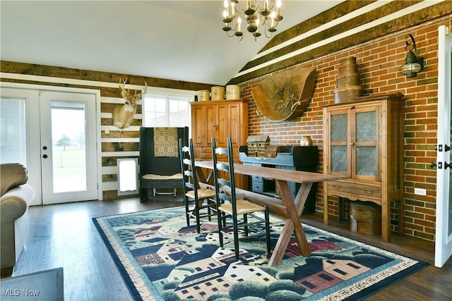 dining area with french doors, vaulted ceiling, dark wood-style floors, and a chandelier