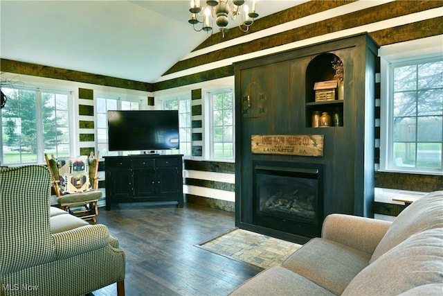 living area with an inviting chandelier, dark wood finished floors, plenty of natural light, and lofted ceiling