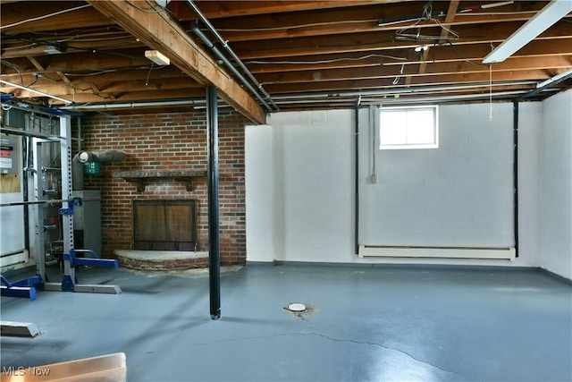 below grade area featuring baseboards, baseboard heating, and a fireplace