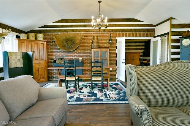 living area featuring wood finished floors, lofted ceiling, a chandelier, and brick wall