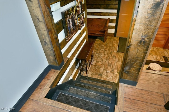 staircase featuring brick floor