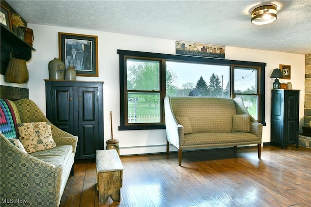 sitting room with hardwood / wood-style flooring and a textured ceiling