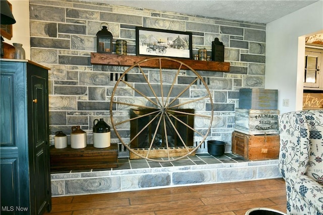 details featuring a textured ceiling and wood finished floors