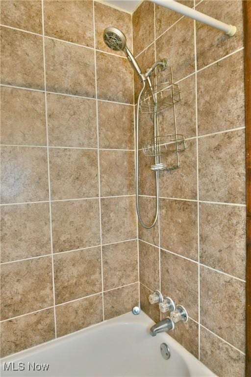 interior details featuring tub / shower combination