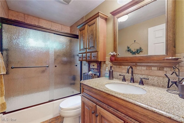 full bath with vanity, decorative backsplash, enclosed tub / shower combo, and toilet