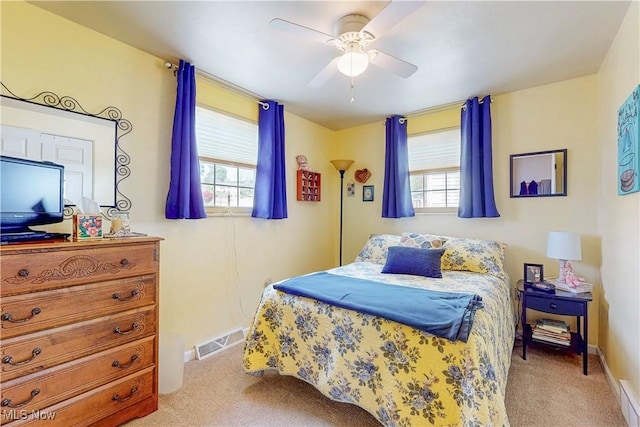 bedroom featuring visible vents, multiple windows, and carpet