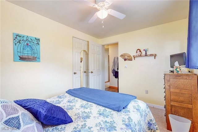 bedroom featuring baseboards, ceiling fan, and carpet flooring