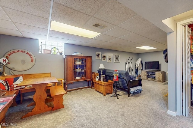 rec room featuring carpet flooring, visible vents, and a paneled ceiling