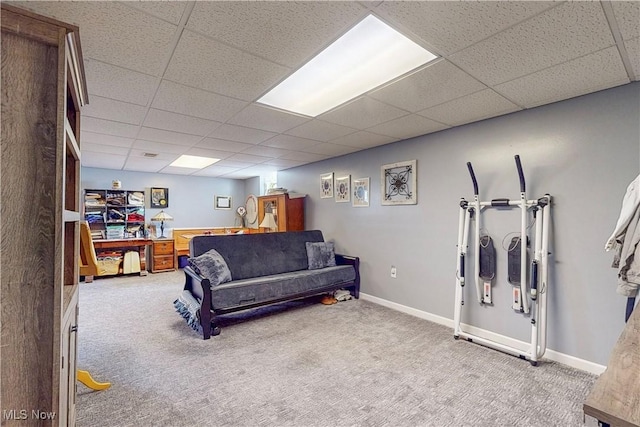 carpeted living room featuring baseboards and a paneled ceiling