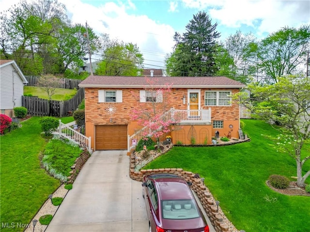 view of front facade featuring a front lawn, fence, brick siding, concrete driveway, and an attached garage