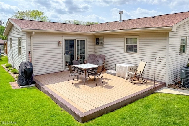 back of house featuring a yard, a wooden deck, outdoor dining area, and roof with shingles