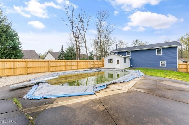 view of pool featuring a diving board, a fenced in pool, a fenced backyard, and a patio area