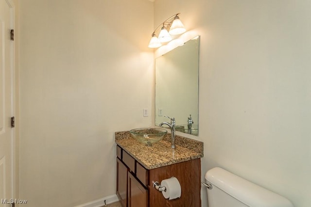 bathroom featuring toilet and vanity
