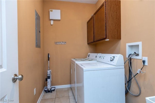 laundry area with baseboards, electric panel, cabinet space, independent washer and dryer, and light tile patterned floors