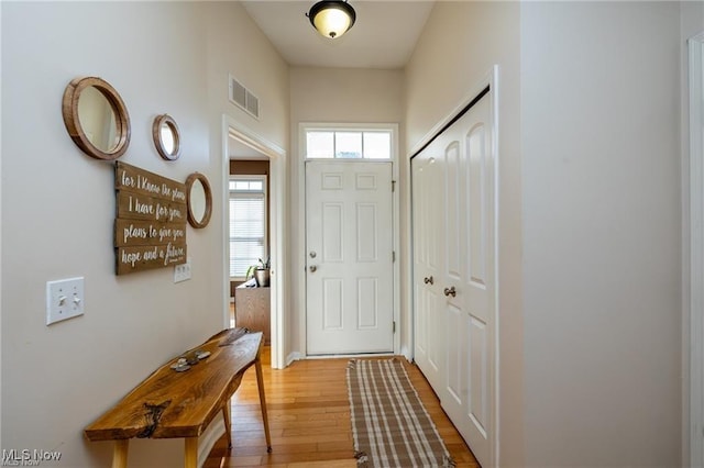 entryway featuring light wood-style floors and visible vents