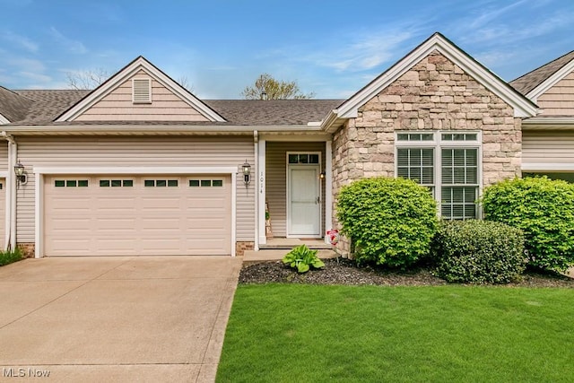 view of front of house featuring driveway, a front lawn, stone siding, and a garage