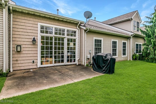 back of property featuring a lawn and a patio area