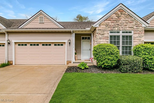 ranch-style home featuring a garage, stone siding, concrete driveway, and a front yard