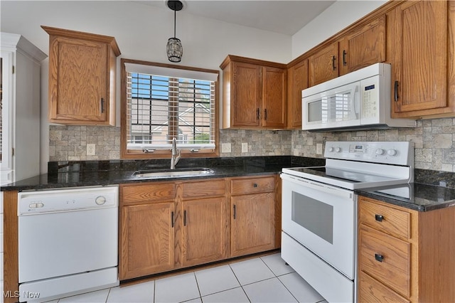 kitchen featuring a sink, decorative backsplash, brown cabinetry, and white appliances