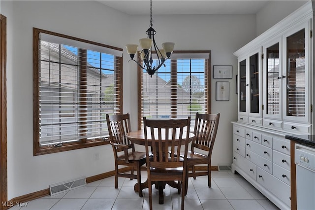 dining room with baseboards, plenty of natural light, a notable chandelier, and visible vents