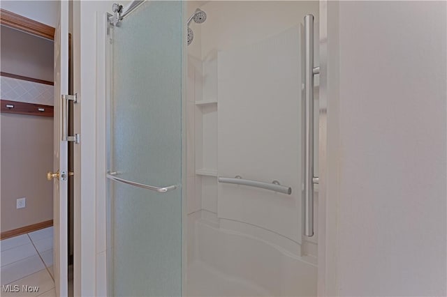 bathroom with tile patterned floors and a shower stall