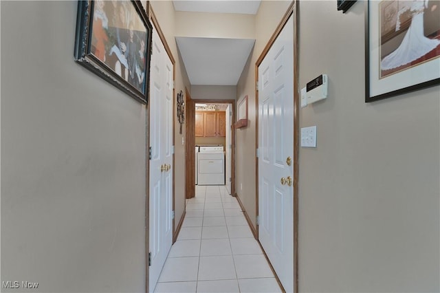 hall with washer / clothes dryer and light tile patterned flooring