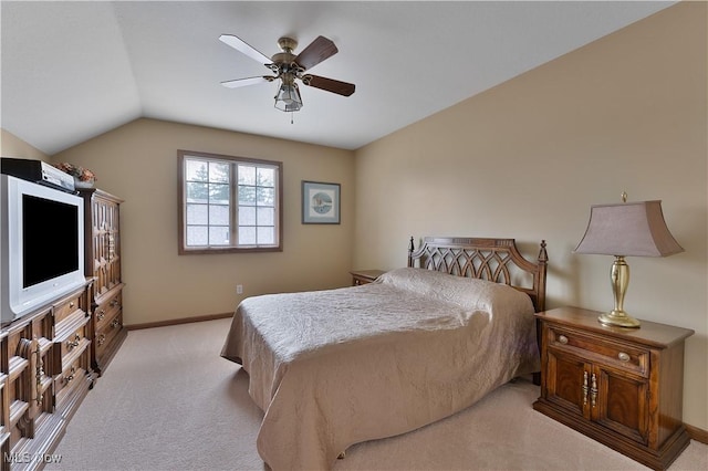 bedroom with a ceiling fan, baseboards, light carpet, and vaulted ceiling